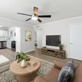 A living room with a ceiling fan and a couch