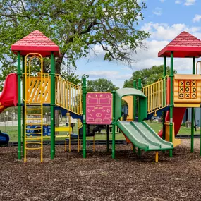 a colorful playground with slides and climbers