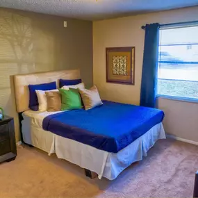 bedroom with carpet and blue curtains