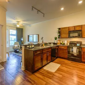 kitchen with dark wood cabinetry and hardwood floors