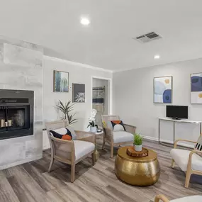 a living room with a fireplace and a tv