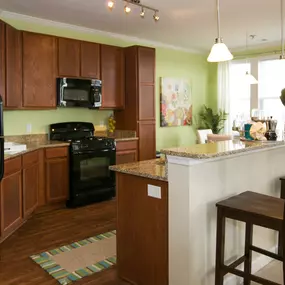 kitchen with island sink and bar chairs