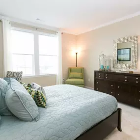 Bedroom with large windows and carpet