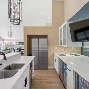 A modern kitchen with a white countertop and stainless steel appliances.