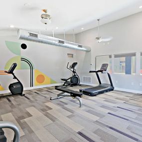 Resident Gym with a Patterned Wall and Exercise Equipment