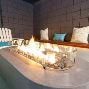 Pool side fire pit table at Westwood Riviera Apartments