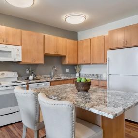 Kitchen with Eat-in Island at Oaks Landing 55+ Apartments