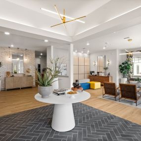 a living room with a white table and a rug