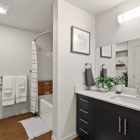 a bathroom with a large mirror and a sink and a shower