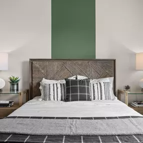 a bedroom with a bed and a green and white wall