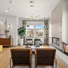 a living room with a table and chairs and a fireplace