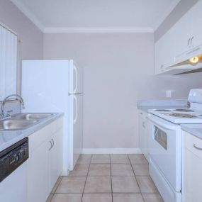 kitchen with white cabinetry, refrigerator, and stove
