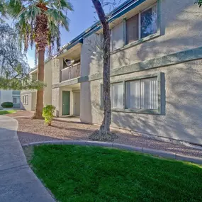 an exterior view of a building with a sidewalk and grass