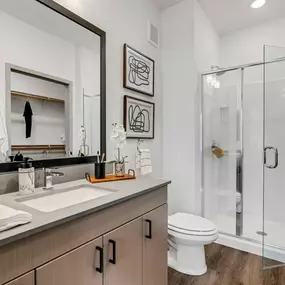 A bathroom with a toilet sink and shower