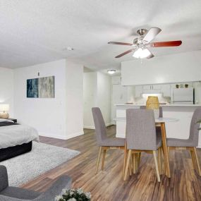 a bedroom with a bed and a ceiling fan and lamp