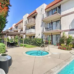 a swimming pool in front of an apartment building