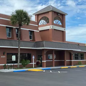 exterior of apartment building with parking lot