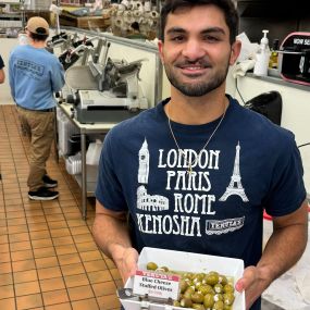 Team member holding stuffed olives