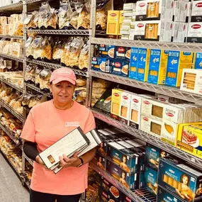 Team member stocking the pasta shelves