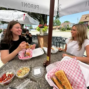 Two women eating at the grill at Tenuta's Deli