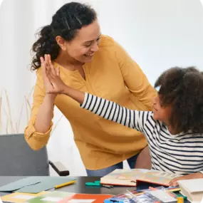 A mother giving her daughter a high-five