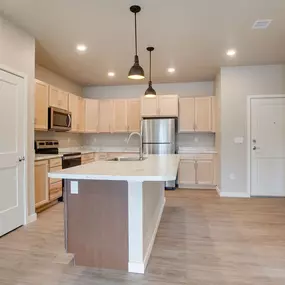 a large kitchen with an island in the middle, Pinehurst Apartments, Baxter, MN