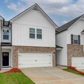 DRB Homes Avery Landing Austin townhome model with brick and white siding
