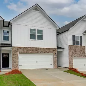 DRB Homes Avery Landing Austin townhome model with brick and white siding