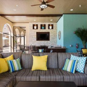 Covered poolside seating with outdoor kitchen
