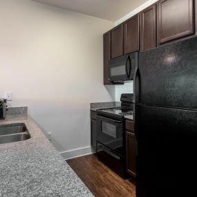 Ample kitchen storage with granite countertops and breakfast bar.