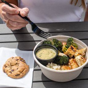 A bowl and a chocolate chip cookie