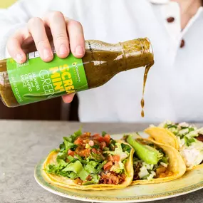 Screamin' Green hot sauce on tacos