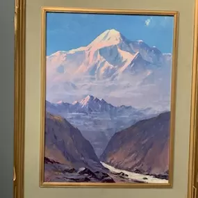 Discover the beauty of nature captured in this stunning painting of a mountain range, elegantly framed in gold. Just as this artwork stands the test of time, so does the coverage we offer for your most valuable assets. Explore our comprehensive insurance options.