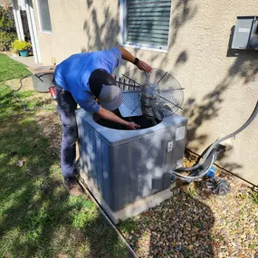 man repairing outdoor hvac unit