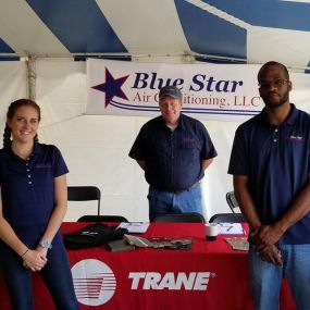 Blue star employees standing at a booth during India festival