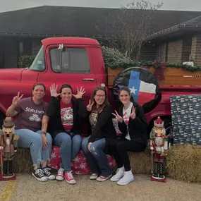 The little red truck has made his way to the office. We would love for you to stop by and take some pictures!  We will have it set up daily during the week as long as the weather permits until Christmas. Check out the silly photo some of our staff enjoyed taking this morning!