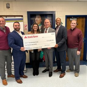 State Farm agents delivering a grant check on behalf of State Farm to An Achievable Dream school in Newport News