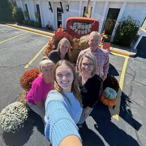 Andy Thoma's - State Farm Insurance Agent and team with fall decor on vintage truck