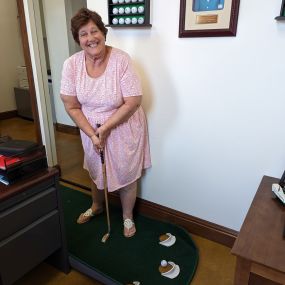 Bob is out of town, so we turned his office into a putting green. Looks like Barbara is ready to play 9 holes on Saturday!