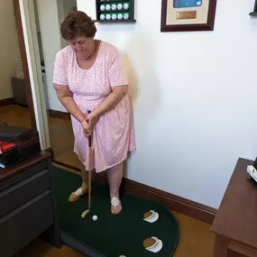 Bob is out of town, so we turned his office into a putting green. Looks like Barbara is ready to play 9 holes on Saturday!