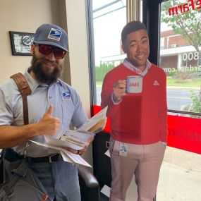 Special delivery! Our friendly mail carrier took a break to chat with Jake at the office.