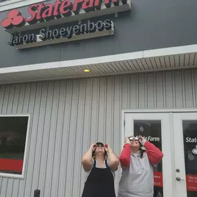 Chasity and Rachel are trying to catch a glimpse between the rain drops.