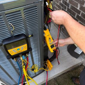 Climate control employee installing new system outside