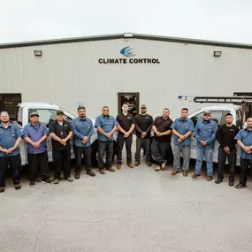 Climate control employees standing outside of office