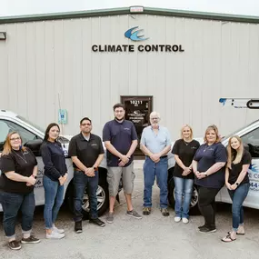 Climate control employees standing outside of office