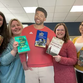 We brought our favorite books to the office today to celebrate.
inny brought Kingdom of Ash
 Valerie brought The Personal Librarian
 Jake brought the Farmer from Merna
 Katie brought A Court of Mist and Fury
 Emily brought The Overstory