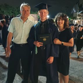 Team member, Christine, and husband with their recently graduated son!