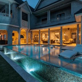 Custom pool with negative edge, rim overflow, and pool lighting