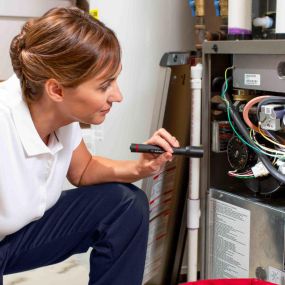 HVAC Technician Inspecting, Trublehsooting, and Repairing a Heater near Tampa