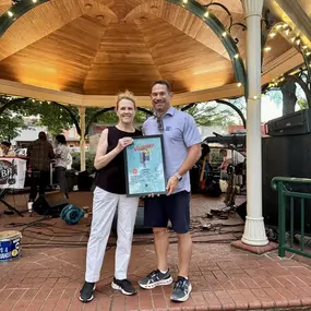 Main Street Collierville presented a framed concert poster to Joe Sarrio State Farm!
